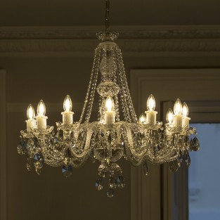 This graceful arm chandelier features rope twist glass arms, glass candle holders and glass cups